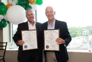 Scott and Chuck holding retirement certificates