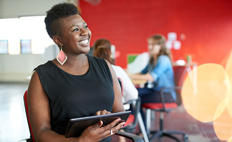 Business woman using tablet in lobby