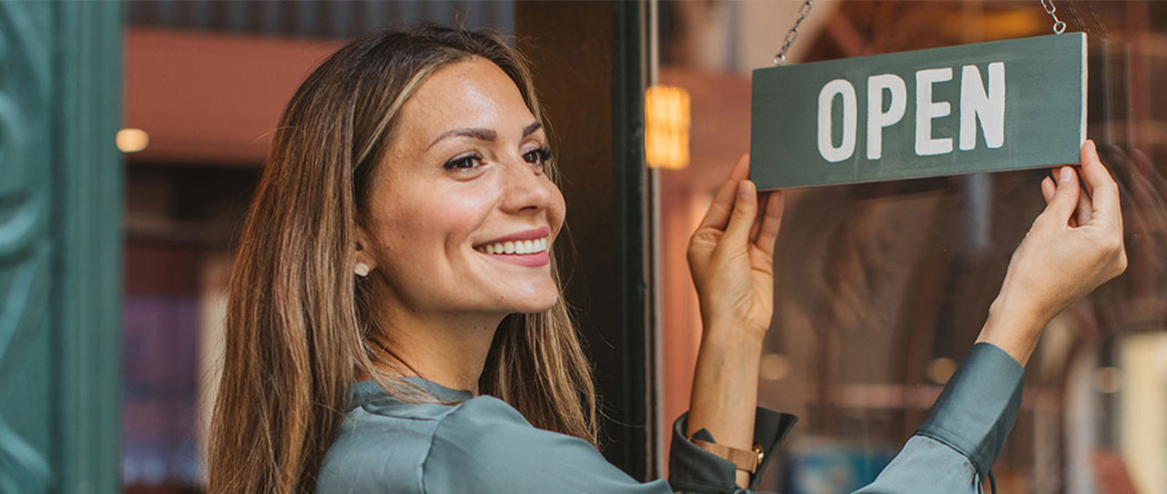 Business owner flipping open sign